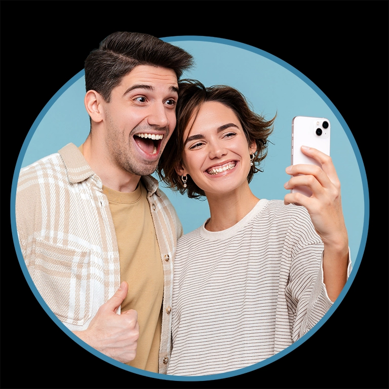 young smiling friends hugging holding mobile phone taking selfie